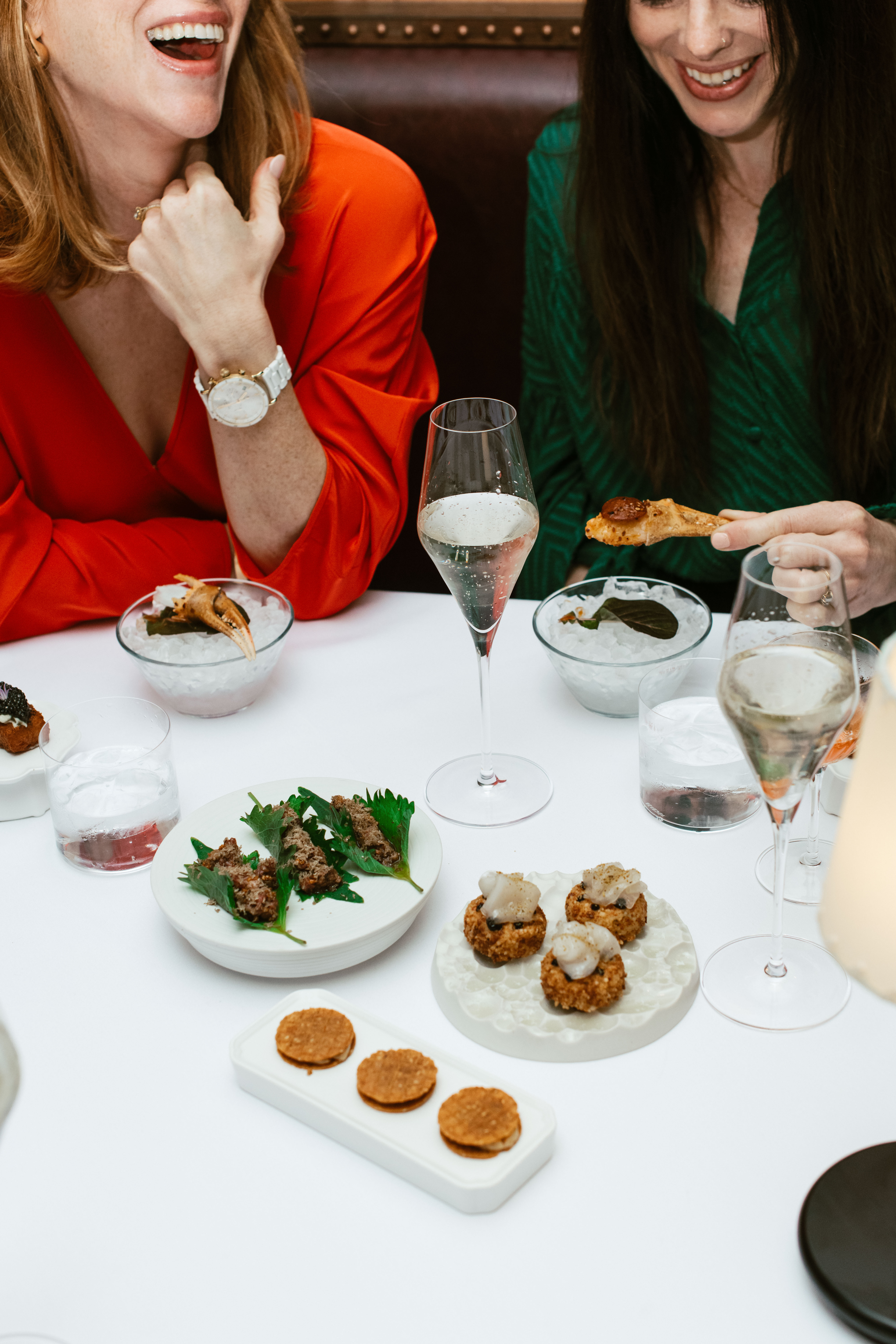 Guests enjoying the tasting menu experience at Nic + Junior’s in River North, Chicago with elegant small plates and champagne