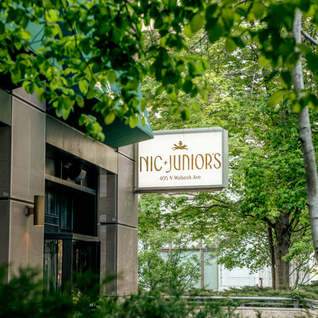 Exterior view of Nic + Junior’s in River North, Chicago, showing the restaurant’s front entrance, signage, and design-forward architecture.