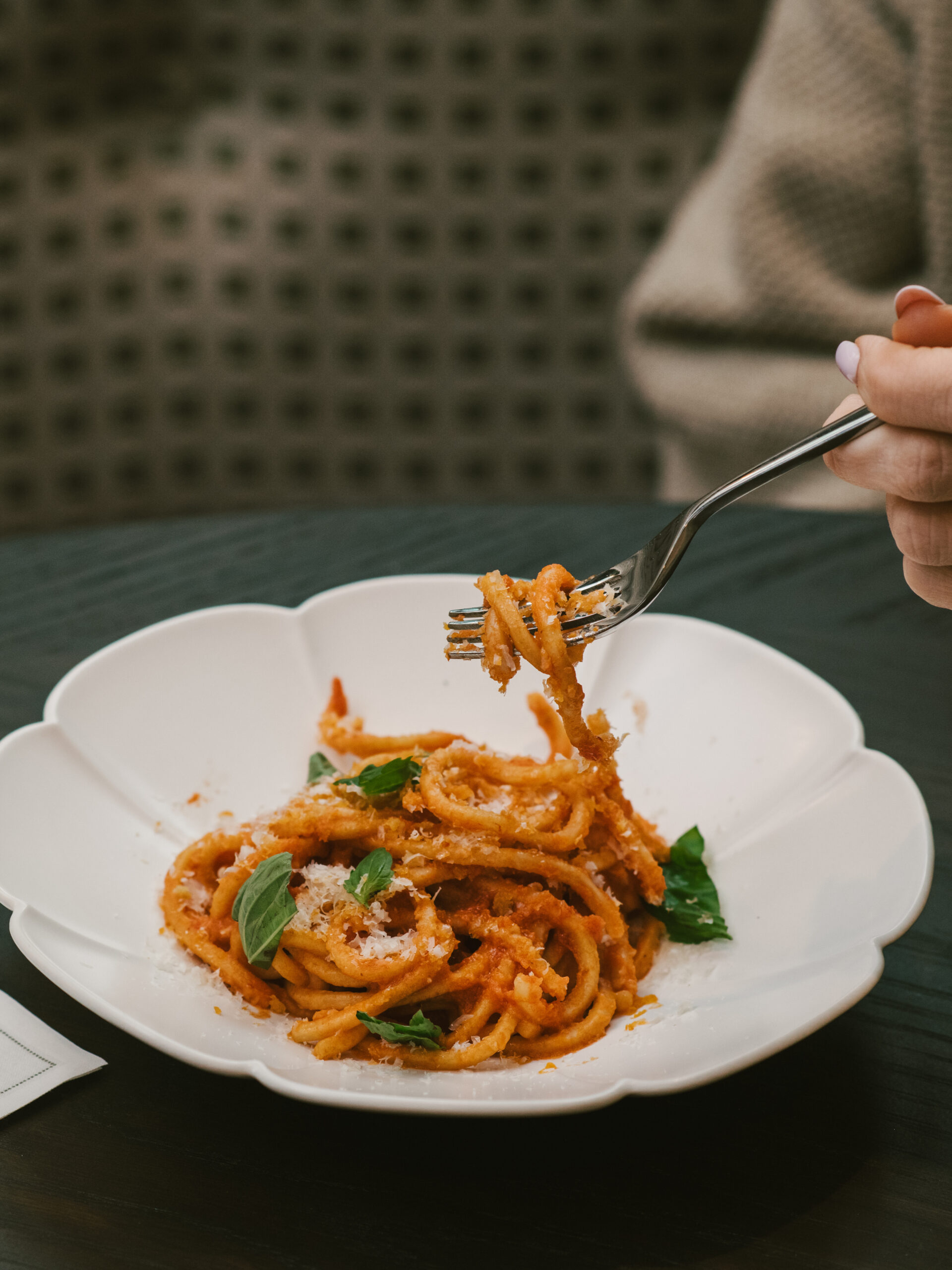 Vertical shot of a signature pasta dish at Nic + Junior’s in River North, Chicago, featuring creamy sauce, fresh herbs, and elegant plating.