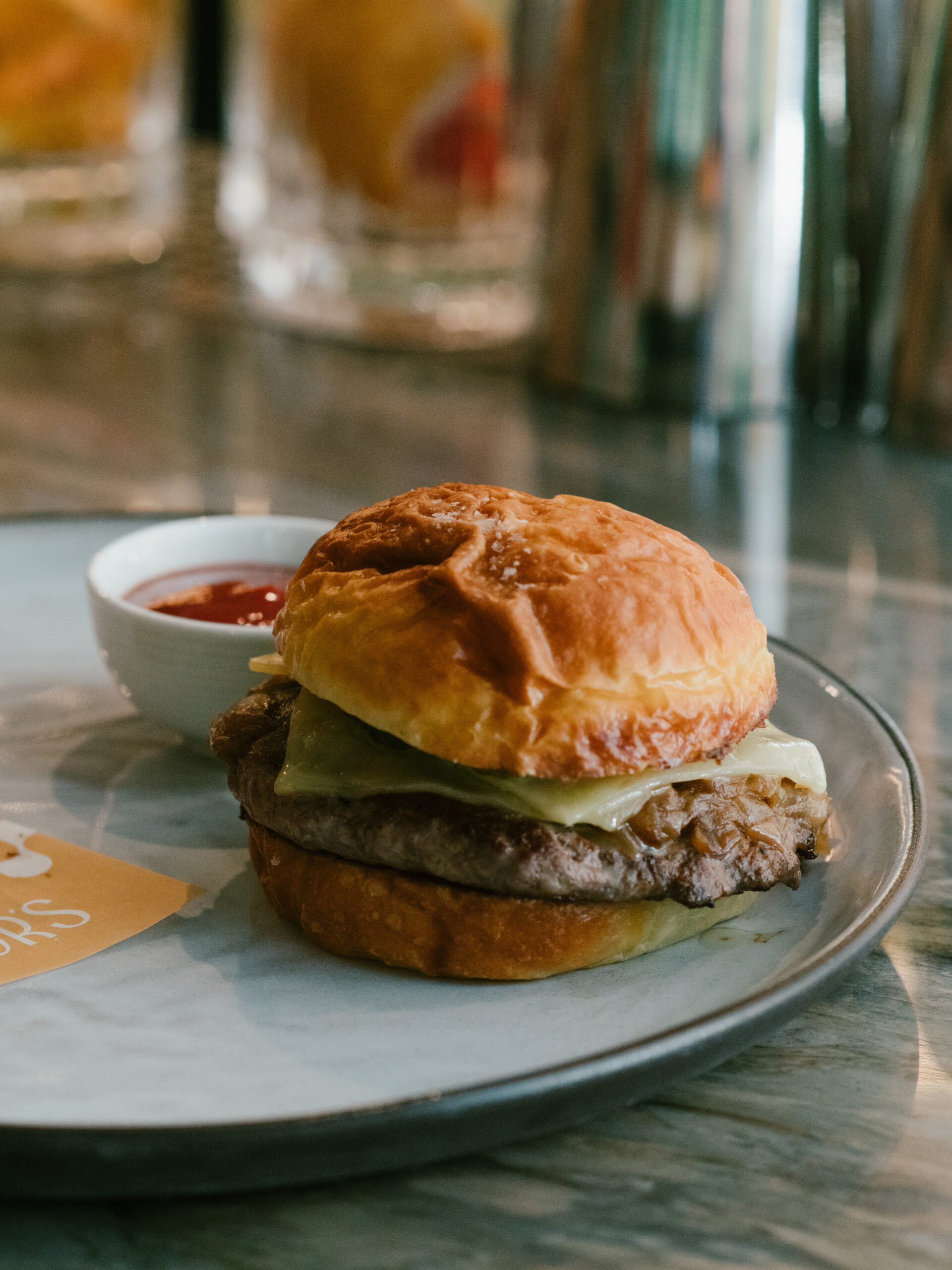 Signature cheeseburger on a brioche bun at Nic + Junior’s in River North, Chicago