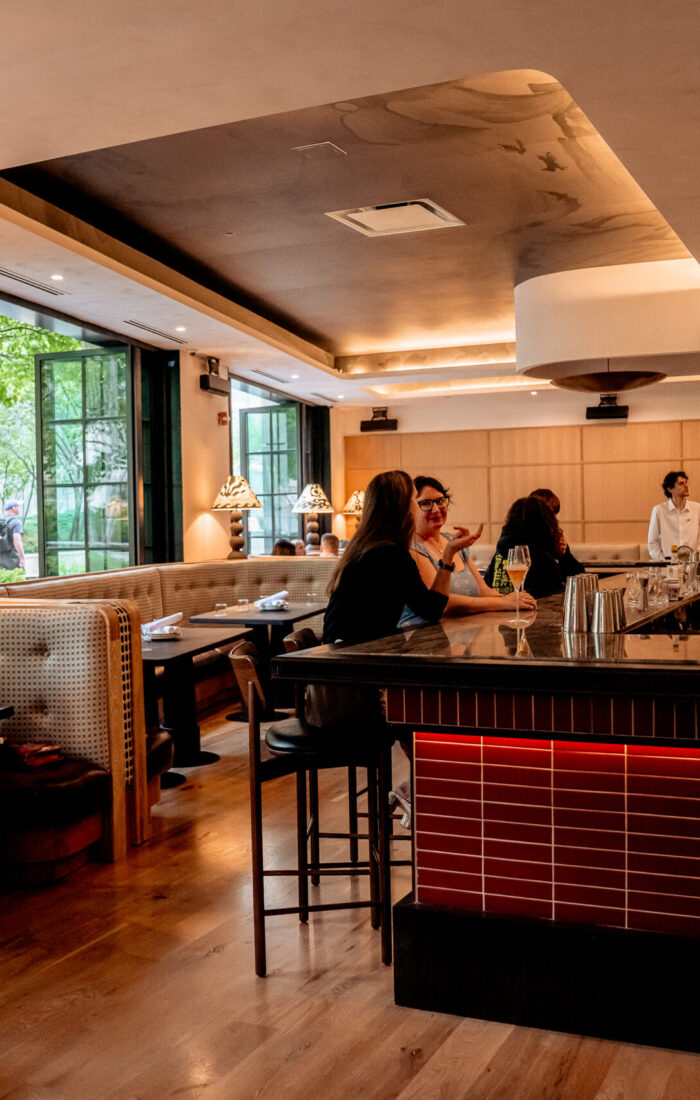 Guests dining and enjoying drinks inside Nic + Junior’s stylish bar and dining room in River North, Chicago